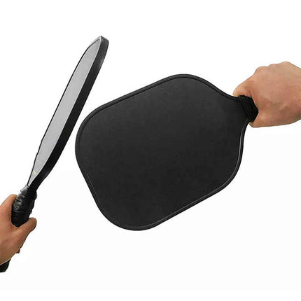 Black leather paddle held by two hands on a white background